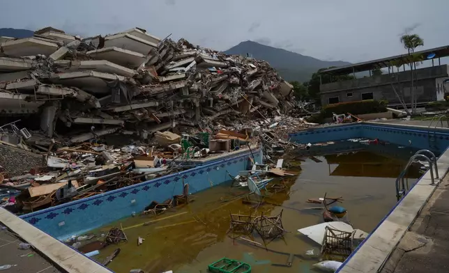 Debris floats in the swimming pool of a building that collapsed in the twin earthquakes that struck La Guaira, Venezuela, Tuesday, June 30, 2026.(AP Photo/Ariana Cubillos)