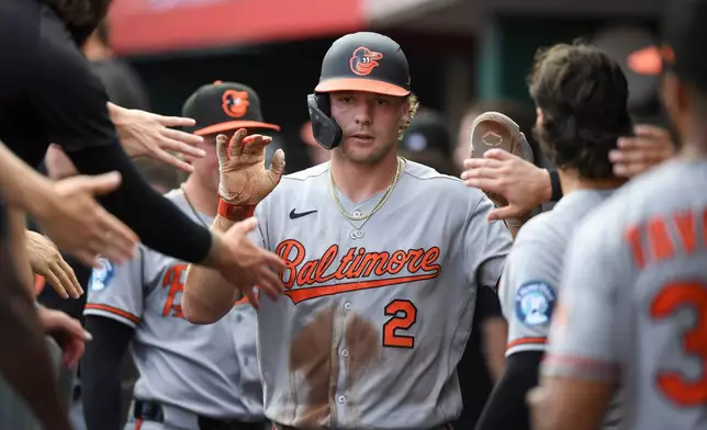 Baltimore Orioles' Gunnar Henderson celebrates with teammates after scoring during the first inning of a baseball game against the Cincinnati Reds in Cincinnati, Friday, July 3, 2026. (AP Photo/Tanner Pearson)