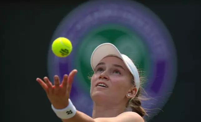 Elena Rybakina of Kazakhstan serves against Elise Mertens of Belgium in their third round women's singles match at the Wimbledon Tennis Championships in London, Saturday, July 4, 2026. (AP Photo/Kirsty Wigglesworth)