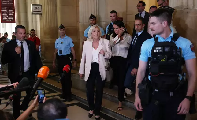 Far-right leader Marine Le Pen leaves the courtroom after the verdict of her appeal trial, in Paris, France, Tuesday, July. 7, 2026. (AP Photo/Aurelien Morissard)