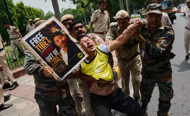 Policemen detain an exiled Tibetan protester outside the Chinese Embassy in New Delhi, India, during a demonstration against political repression in Tibet, Tuesday, July 7, 2026. (AP Photo/Manish Swarup)