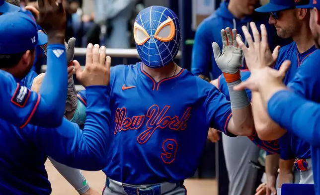 New York Mets' A.J. Ewing (9) wears a Spider-Man mask while celebrating after his solo home run against the Atlanta Braves during the second inning of a baseball game, Sunday, July 5, 2026, in Atlanta. (AP Photo/Erik S. Lesser)