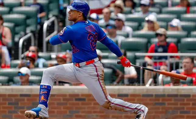 New York Mets designated hitter Juan Soto watches his two-run single against the Atlanta Braves during the second inning of a baseball game, Sunday, July 5, 2026, in Atlanta. (AP Photo/Erik S. Lesser)