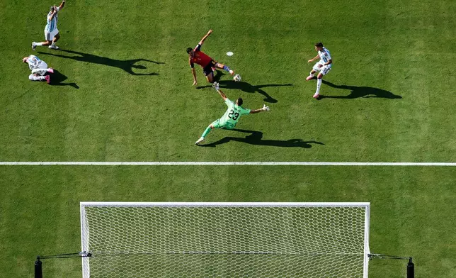 Spain's Mikel Merino (6) tries to score past Argentina goalkeeper Emiliano Martinez (23) as Argentina's Nicolas Otamendi (19), left, and Argentina's Facundo Medina (25), top left, react during the World Cup final soccer match between Spain and Argentina in East Rutherford, N.J., near New York, Sunday, July 19, 2026. (AP Photo/Matt Slocum)