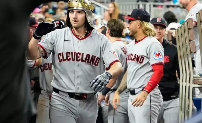Cleveland Guardians' Chase DeLauter celebrates in the dugout after hitting a two run home run during the fourth inning of a baseball game against the Miami Marlins, Friday, July 10, 2026, in Miami. (AP Photo/Lynne Sladky)