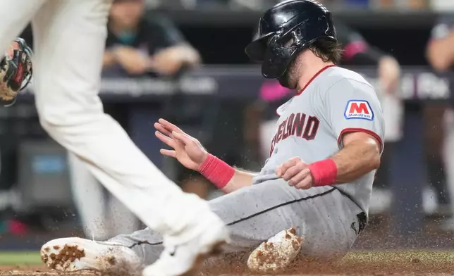 Cleveland Guardians' Austin Hedges scores on a sacrifice fly hit by Travis Bazzana during the fifth inning of a baseball game against the Miami Marlins, Friday, July 10, 2026, in Miami. (AP Photo/Lynne Sladky)
