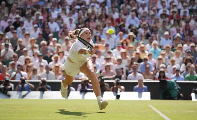 Karolina Muchova of the Czech Republic returns the ball to Coco Gauff of the United States celebrates a point against in their semifinal women's singles match at the Wimbledon Tennis Championships in London, Thursday, July 9, 2026. (AP Photo/Kin Cheung)