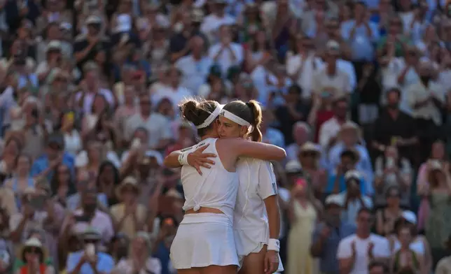 Linda Noskova of Czech Republic, back to the camera, and Karolina Muchova of Czech Republic hug each other at the end of the women's singles final at Wimbledon Tennis Championships in London, Saturday, July 11, 2026. (AP Photo/Kirsty Wigglesworth)