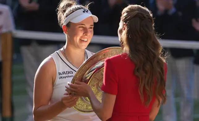 Linda Noskova of Czech Republic receives the champion trophy from Britain's Princess Kate after defeating Karolina Muchova of Czech Republic the women's singles final at Wimbledon Tennis Championships in London, Saturday, July 11, 2026. (AP Photo/Kin Cheung)