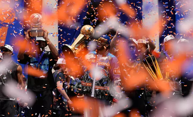 New York Knicks center Karl-Anthony Towns, center, celebrates with teammates during the New York Knicks' NBA championship parade Thursday, June 18, 2026, in New York. (AP Photo/Yuki Iwamura)