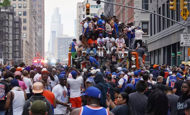 Fans celebrate during the New York Knicks' NBA championship parade Thursday, June 18, 2026, in New York. (AP Photo/Ryan Murphy)