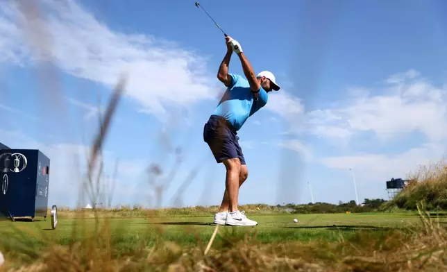 US golfer Scottie Scheffler tees off during a practice round at the British Open Golf Championship at Royal Birkdale, Southport, England, Monday, July 13, 2026. (AP Photo/Peter Morrison)