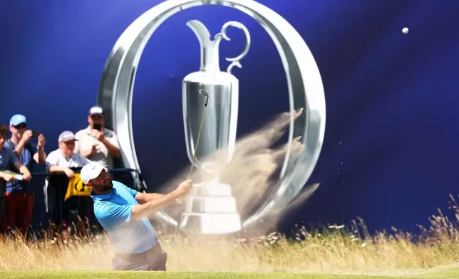 US golfer Scottie Scheffler plays out of the bunker during a practice round at the British Open Golf Championship at Royal Birkdale, Southport, England, Monday, July 13, 2026. (AP Photo/Peter Morrison)