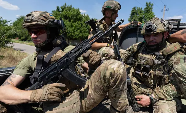 In this photo provided by Ukraine's 93rd Kholodnyi Yar Separate Mechanized Brigade press service, Soldiers of the Alcatraz batalion, patrol the frontline city Druzhkovka, Donetsk region, Ukraine, Thursday, July 2, 2026. (Iryna Rybakova/Ukraine's 93rd Mechanized Brigade via AP)