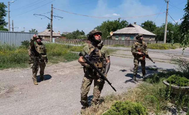 In this photo provided by Ukraine's 93rd Kholodnyi Yar Separate Mechanized Brigade press service, Soldiers of the Alcatraz batalion, patrol the frontline city Druzhkovka, Donetsk region, Ukraine, Thursday, July 2, 2026. (Iryna Rybakova/Ukraine's 93rd Mechanized Brigade via AP)