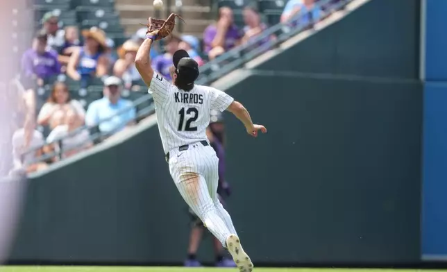 Colorado Rockies third baseman Kyle Karros pulls in a pop fly off the bat of Miami Marlins' Joe Mack in the sixth inning of a baseball game Thursday, July 2, 2026, in Denver. (AP Photo/David Zalubowski)