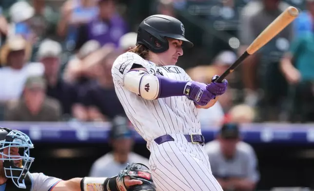 Colorado Rockies' Jake McCarthy hits a two-run single off Miami Marlins relief pitcher Calvin Faucher in the sixth inning of a baseball game Thursday, July 2, 2026, in Denver. (AP Photo/David Zalubowski)