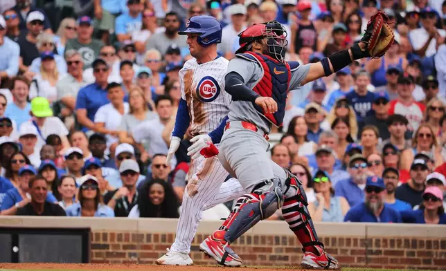 Chicago Cubs' Alex Bregman, center left, scores on an RBI single hit by teammate Nico Hoerner during the first inning of a baseball game against the St. Louis Cardinals, Sunday, July 5, 2026, in Chicago. (AP Photo/Melissa Tamez)