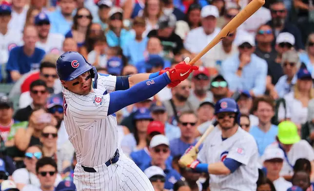 Chicago Cubs' Nico Hoerner hits an RBI single during the first inning of a baseball game against the St. Louis Cardinals, Sunday, July 5, 2026, in Chicago. (AP Photo/Melissa Tamez)