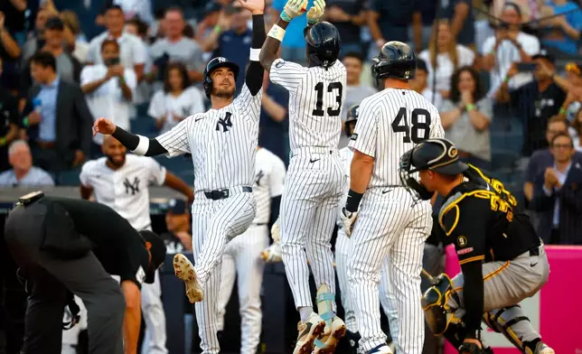 New York Yankees' Cody Bellinger, center left, and Jazz Chisholm Jr. (13) celebrate after Chisholm's home run against the Pittsburgh Pirates during the first inning of a baseball game, Monday, July 20, 2026, in New York. (AP Photo/Noah K. Murray)