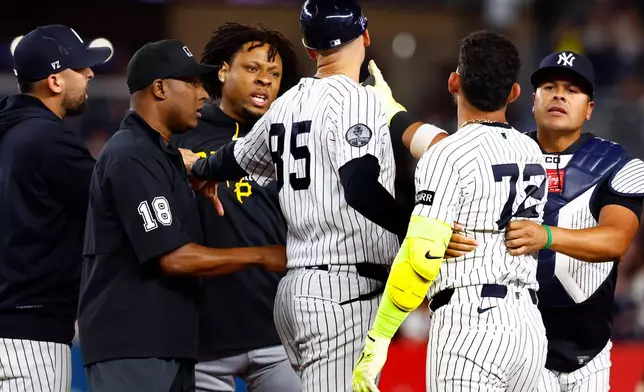 Pittsburgh Pirates' Gregory Soto, left, exchanges words with New York Yankees' José Caballero (72), right, during the ninth inning of a baseball game, Monday, July 20, 2026 in New York. (AP Photo/Noah K. Murray)