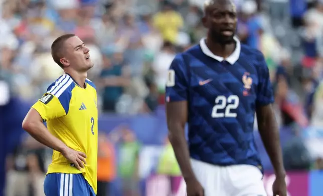 Sweden's Gustaf Lagerbielke (2) reacts after their loss in the World Cup round of 32 soccer match between France and Sweden in East Rutherford, N.J., near New York, Tuesday, June 30, 2026. (AP Photo/Adam Hunger)