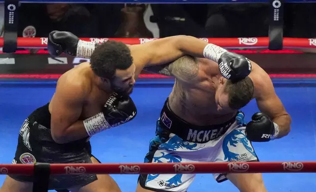 FILE - Britain's Moses Itauma, left, lands a blow on Australia's Demsey McKean in their heavyweight boxing fight in Riyadh, Saudi Arabia, Saturday, Dec. 21, 2024. (AP Photo/Frank Augstein, File)