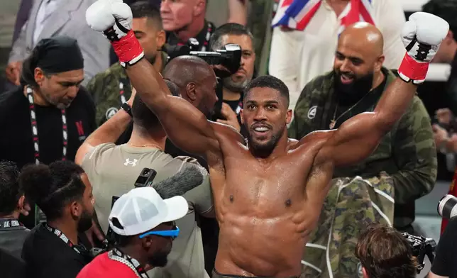 FILE - Anthony Joshua reacts after defeating Jake Paul in their heavyweight boxing match, Friday, Dec. 19, 2025, in Miami. (AP Photo/Lynne Sladky, File)