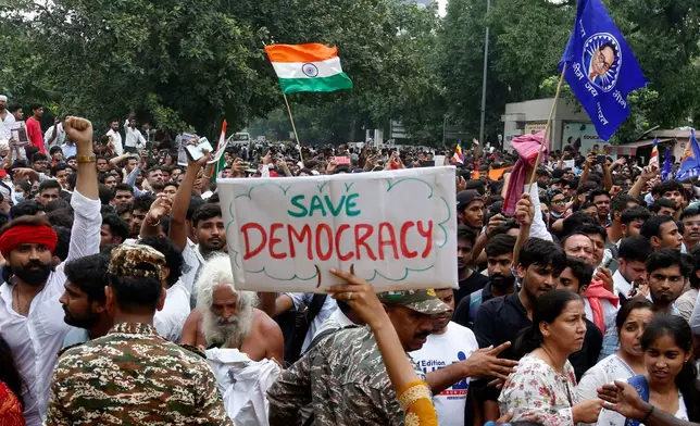 Supporters of the Cockroach Janta Party attempt to march to India's Parliament, demanding the resignation of the education minister, in New Delhi, Monday, July 20, 2026. (AP Photo/Shekhar Yadav)
