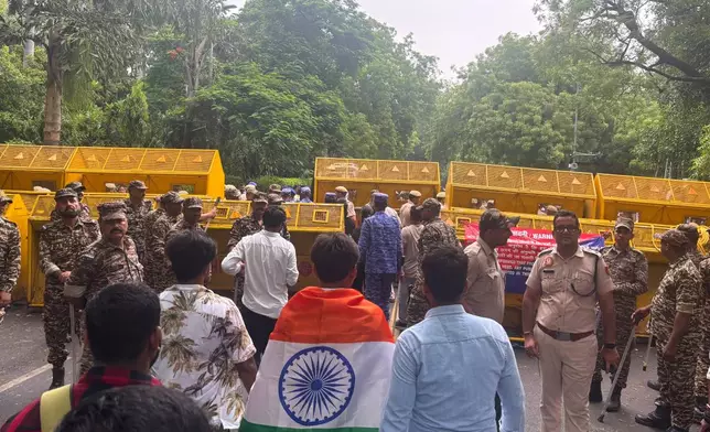 Supporters of the Cockroach Janta Party arrive as they gather to march to India's Parliament, demanding the resignation of the education minister, in New Delhi, Monday, July 20, 2026.(AP Photo/Manish Swarup)