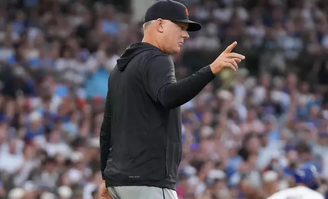 Detroit Tigers manager A.J. Hinch gestures as he makes a pitching change against the Chicago Cubs during the first inning of a baseball game Tuesday, July 21, 2026, in Chicago. (AP Photo/David Banks)