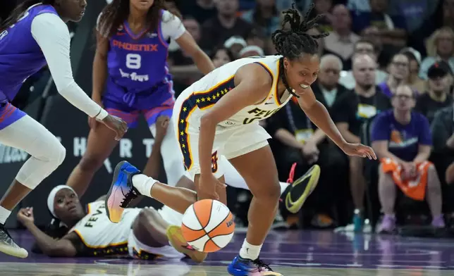 Indiana Fever guard Kelsey Mitchell, right, chases down a loose ball as Phoenix Mercury guard-forward Kahleah Copper, left, Fever guard Raven Johnson and Mercury guard Monique Akoa Makani (8) look on during the second half of a WNBA basketball game, Thursday, July 9, 2026, in Phoenix. (AP Photo/Ross D. Franklin)