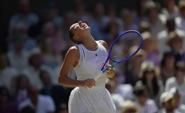 Marta Kostyuk of Ukraine reacts to losing a point against Jasmine Paolini of Italy in their quarter-final women's singles match at the Wimbledon Tennis Championships in London, Wednesday, July 8, 2026. (AP Photo/Brian Inganga)