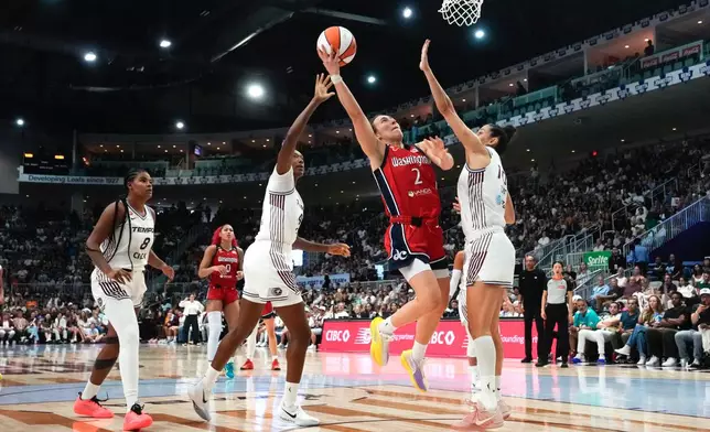 Washington Mystics' Nyla Harris (2) shoots on Toronto Tempo's Marie Conde during the second half of a WNBA basketball game in Toronto, Tuesday, July 14, 2026. (Chris Young/The Canadian Press via AP)