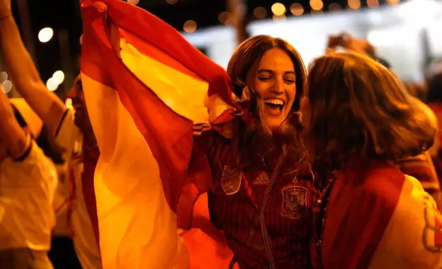 Spanish fans celebrate in central Madrid after Spain defeated Argentina in the World Cup final soccer match in East Rutherford, N.J., near New York, Sunday, July 19, 2026. (AP Photo/Bernat Armangue)