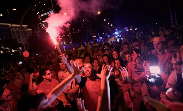 Spanish fans celebrate in central Madrid after Spain defeated Argentina in the World Cup final soccer match in East Rutherford, N.J., near New York, Sunday, July 19, 2026. (AP Photo/Bernat Armangue)
