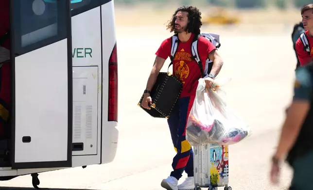 Spain's Marc Cucurella arrives with the rest of his team at Madrid airport on Monday, July 20, 2026, after being crowned World Cup champions with a victory over Argentina in the final in East Rutherford, N.J., near New York. (AP Photo/Manu Fernandez)