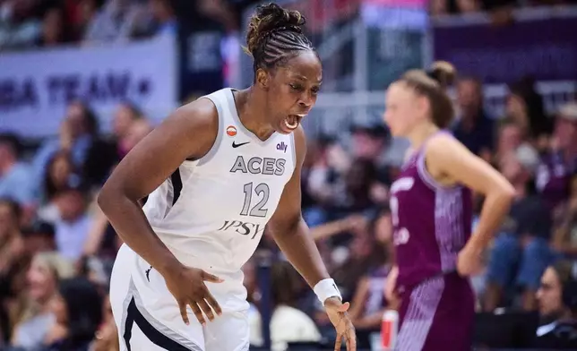 Las Vegas Aces' Chelsea Gray (12) reacts after scoring against the Toronto Tempo during the first half of a WNBA basketball game in Toronto, on Monday, July 20, 2026. (Sammy Kogan/The Canadian Press via AP)