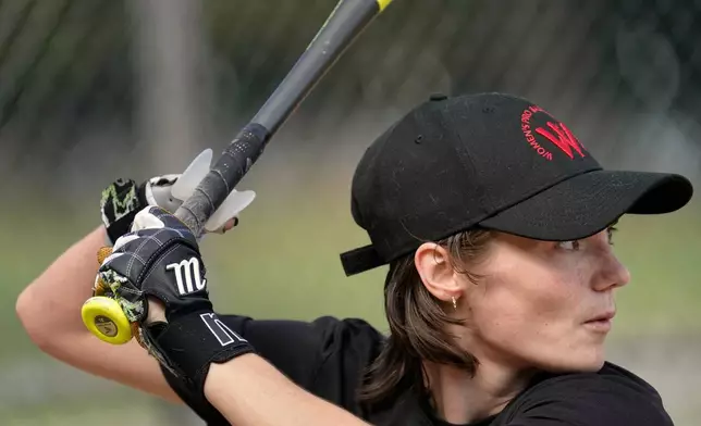 Brittany Apgar, who was born without a right hand, prepares to hit at a field in Greensboro, N.C., Wednesday, July 22, 2026 before joining the Los Angeles team in the Women's Pro Baseball League. (AP Photo/Chuck Burton)