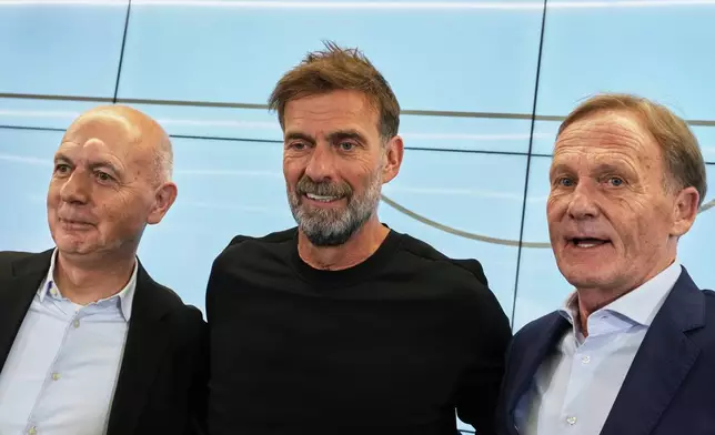 Newly appointed head coach of the German national soccer team Juergen Klopp, center, poses for a photo with DFB President Bernd Neuendorf during a press conference at the headquarters of the German Football Association DFB in Frankfurt, Germany, Friday, July 24, 2026. (AP Photo/Michael Probst)