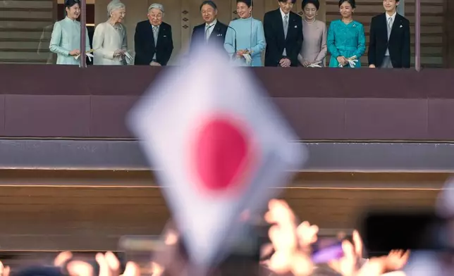 FILE - Japan's Emperor Naruhito, fourth left, Empress Masako, fifth left, and other royal family members greet well-wishers from the balcony during a public appearance for New Year's celebrations at the Imperial Palace, Jan. 2, 2026, in Tokyo. (AP Photo/Eugene Hoshiko, File)
