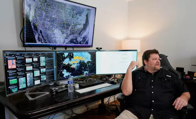 Will Minkoff of Nashville Severe Weather sits at his desk Monday, April 20, 2026, in Nashville, Tenn. (AP Photo/George Walker IV)