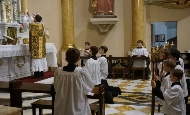 The Rev. John Ubel, pastor of the Church of Saint Agnes, celebrates the eucharistic prayer facing the altar, in the traditional custom, during one of the Catholic parish’s Latin Masses in St. Paul, Minn., Sunday, June 28, 2026. (AP Photo/Giovanna Dell’Orto)