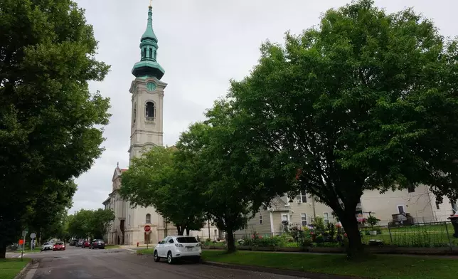 The Church of Saint Agnes, built in the early 20th century for German-speaking immigrants, now offers Masses in Latin and in English in a diverse inner-city neighborhood of St. Paul, Minn., as seen on Sunday, June 28, 2026. (AP Photo/Giovanna Dell’Orto)
