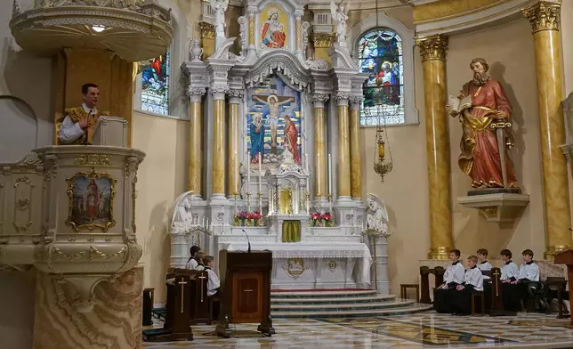 The Rev. John Ubel, pastor of the Church of Saint Agnes, preaches his homily about faithfulness to both tradition and the Vatican during one of the Catholic parish’s Latin Masses in St. Paul, Minn., Sunday, June 28, 2026. (AP Photo/Giovanna Dell’Orto)