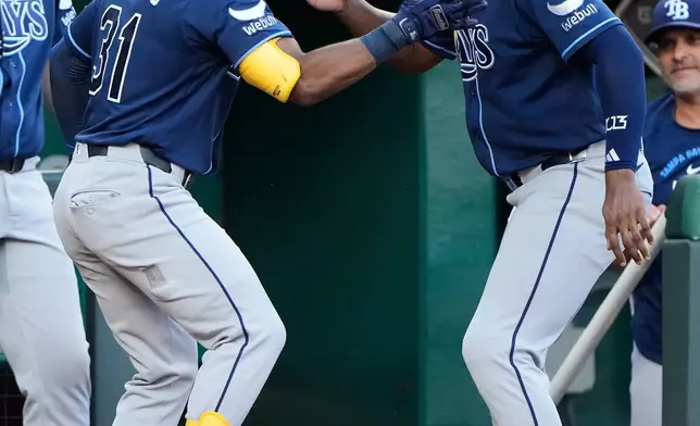 Tampa Bay Rays' Cedric Mullins (31) celebrates with Junior Caminero after hitting a two-run home run during the fifth inning of a baseball game against the Kansas City Royals, Thursday, July 2, 2026, in Kansas City, Mo. (AP Photo/Charlie Riedel)