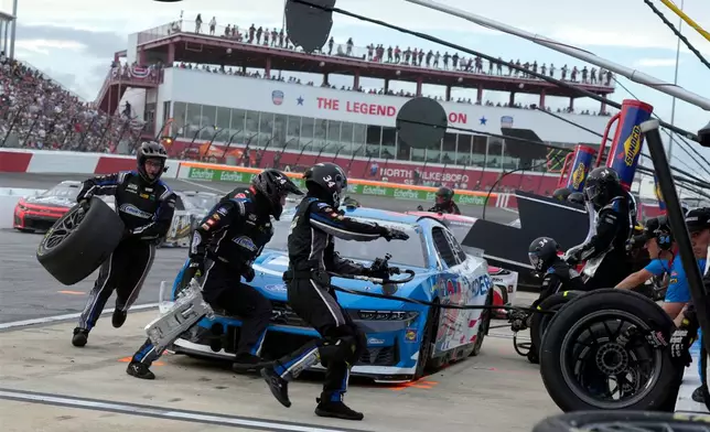 Drivers perform a pit stop on driver Todd Gilliland's car during a NASCAR Cup Series auto race in North Wilkesboro, N.C., Sunday, July 19, 2026. (AP Photo/Chuck Burton)