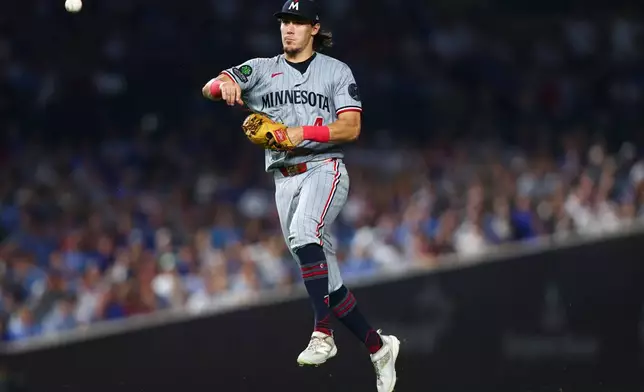 Minnesota Twins shortstop Tristan Gray throws to first base during the sixth inning of a baseball game against the Chicago Cubs in Chicago, Friday, July 17, 2026. (AP Photo/Jessie Alcheh)