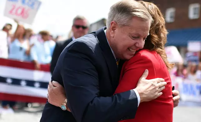 FILE - Sen. Lindsey Graham, R-S.C., left, hugs his sister Darline Graham Nordone, after announcing his bid for presidency, June 1, 2015, in Central, S.C. (AP Photo/Rainier Ehrhardt, File)