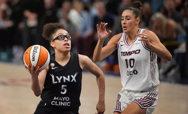 Minnesota Lynx guard Olivia Miles (5) drives around Toronto Tempo forward Maria Conde (10) to shoot in the fourth quarter of a WNBA basketball game Tuesday, July 28, 2026, in Minneapolis. (Jeff Wheeler/Minnesota Star Tribune via AP)